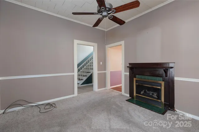 a view of an empty room with fire place and a fireplace