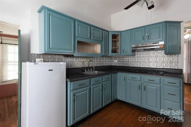 a kitchen with stainless steel appliances granite countertop a sink and a microwave