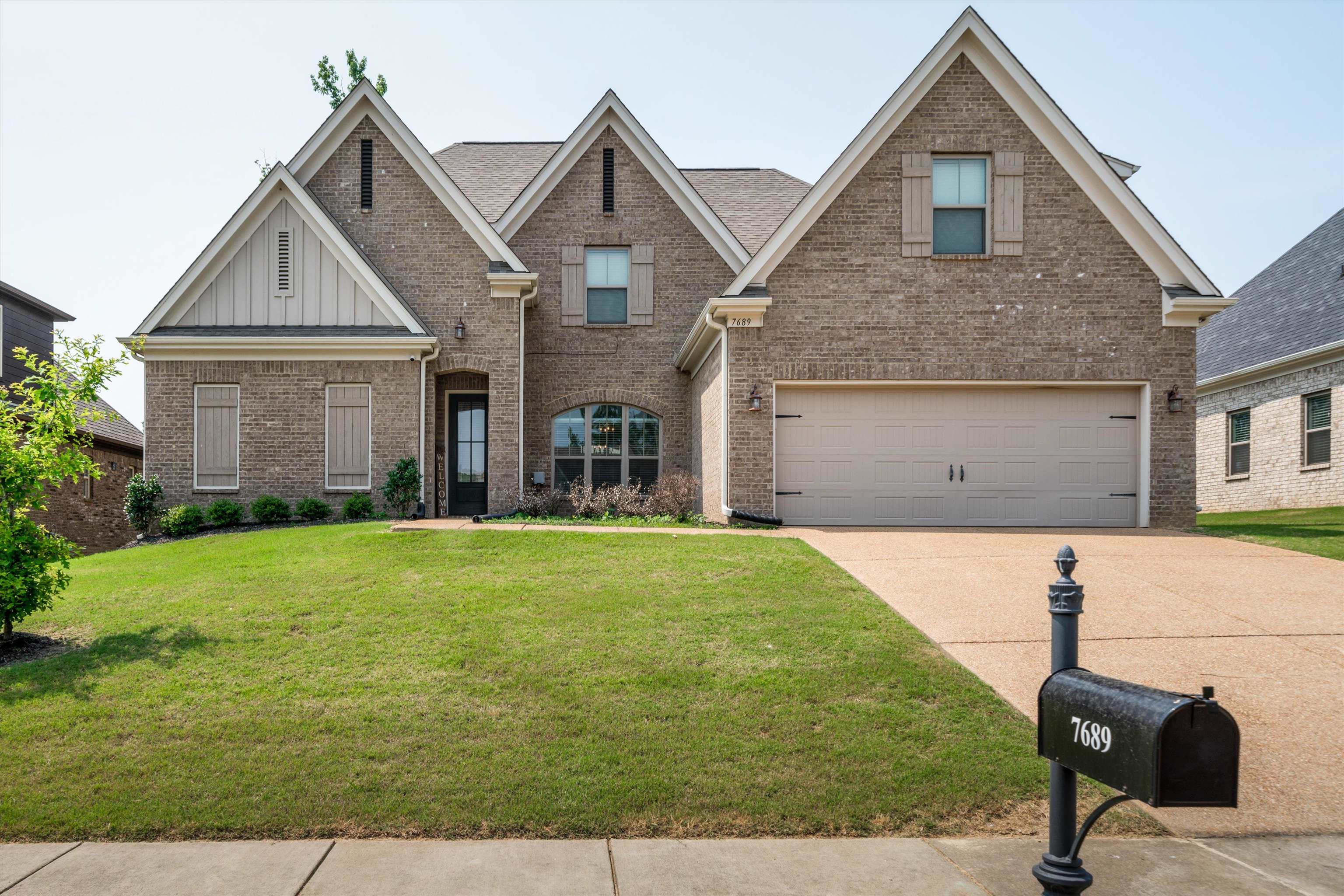 a front view of a house with a yard