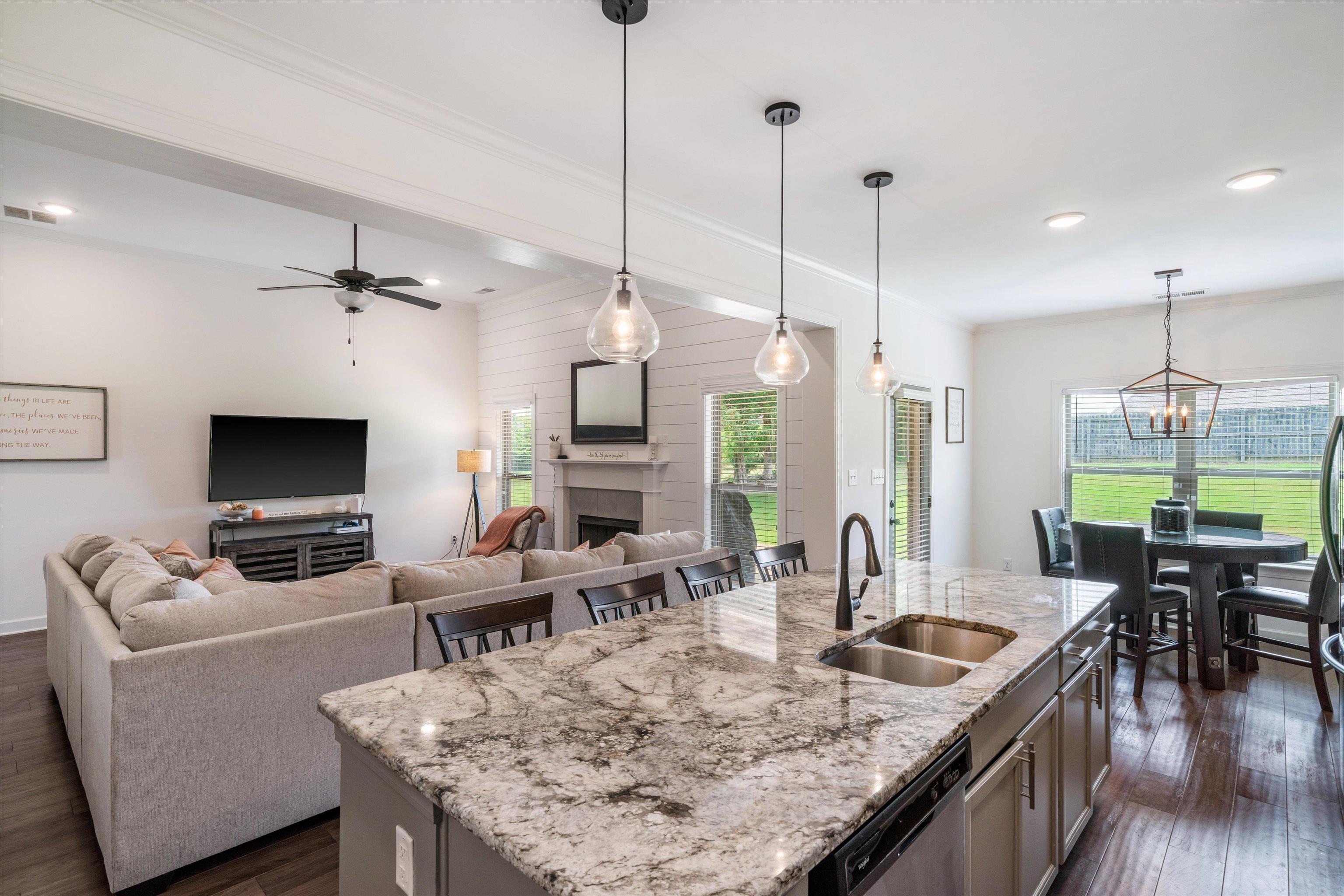 7689 Elpine Gray Drive Bartlett, TN 38002 - Photo 6 of 14 a view of a dining room and livingroom furniture wooden floor a rug a flat screen tv a rug and a chandelier
