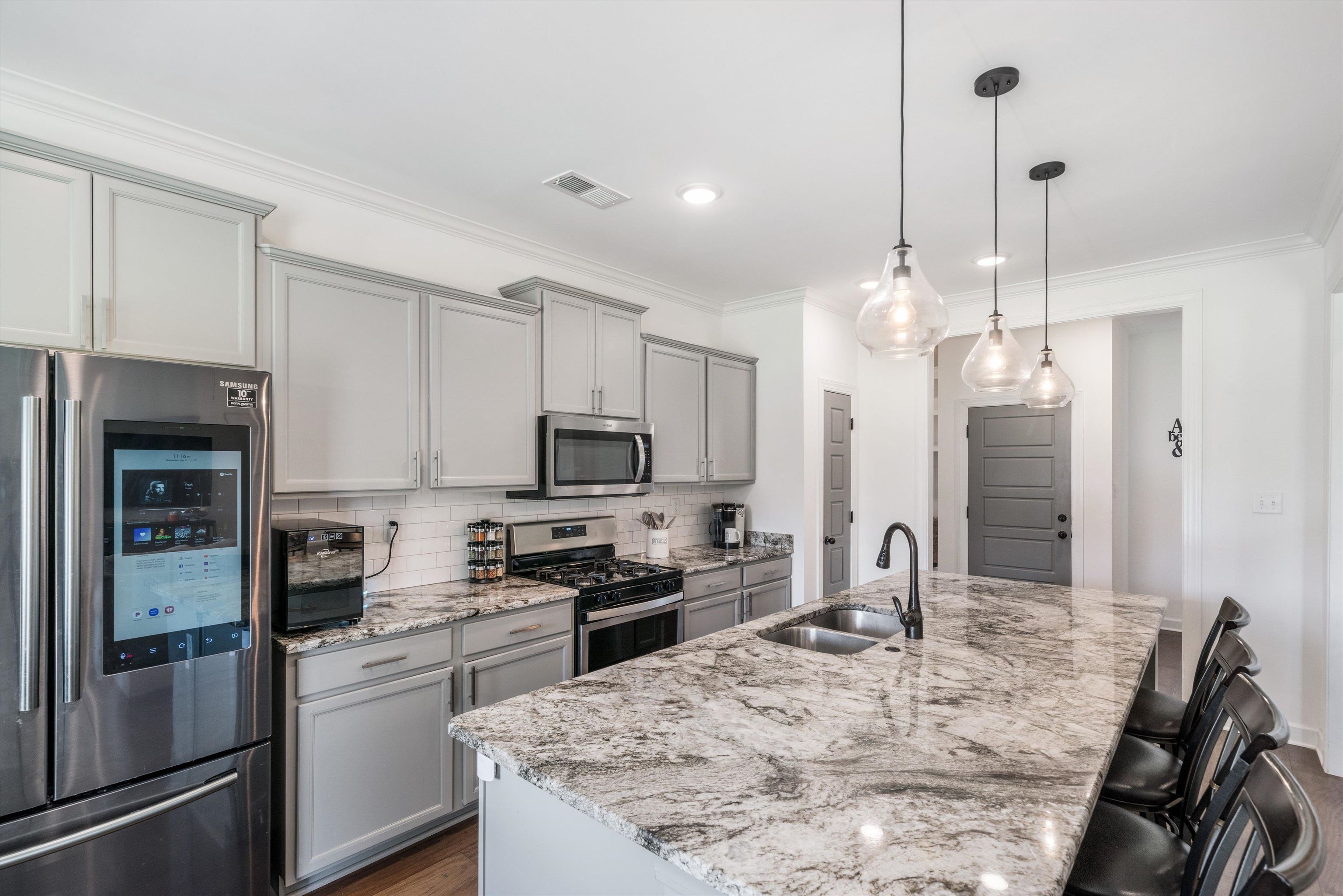 7689 Elpine Gray Drive Bartlett, TN 38002 - Photo 7 of 14 a kitchen with kitchen island a counter top space appliances and cabinets