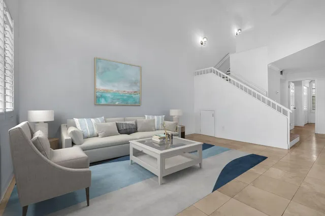 a living room with furniture and a potted plant