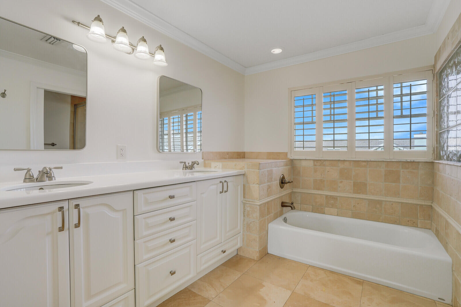 705 Mainsail Circle Jupiter, FL 33477 - Photo 33 of 51 a bathroom with a tub a sink double and mirror