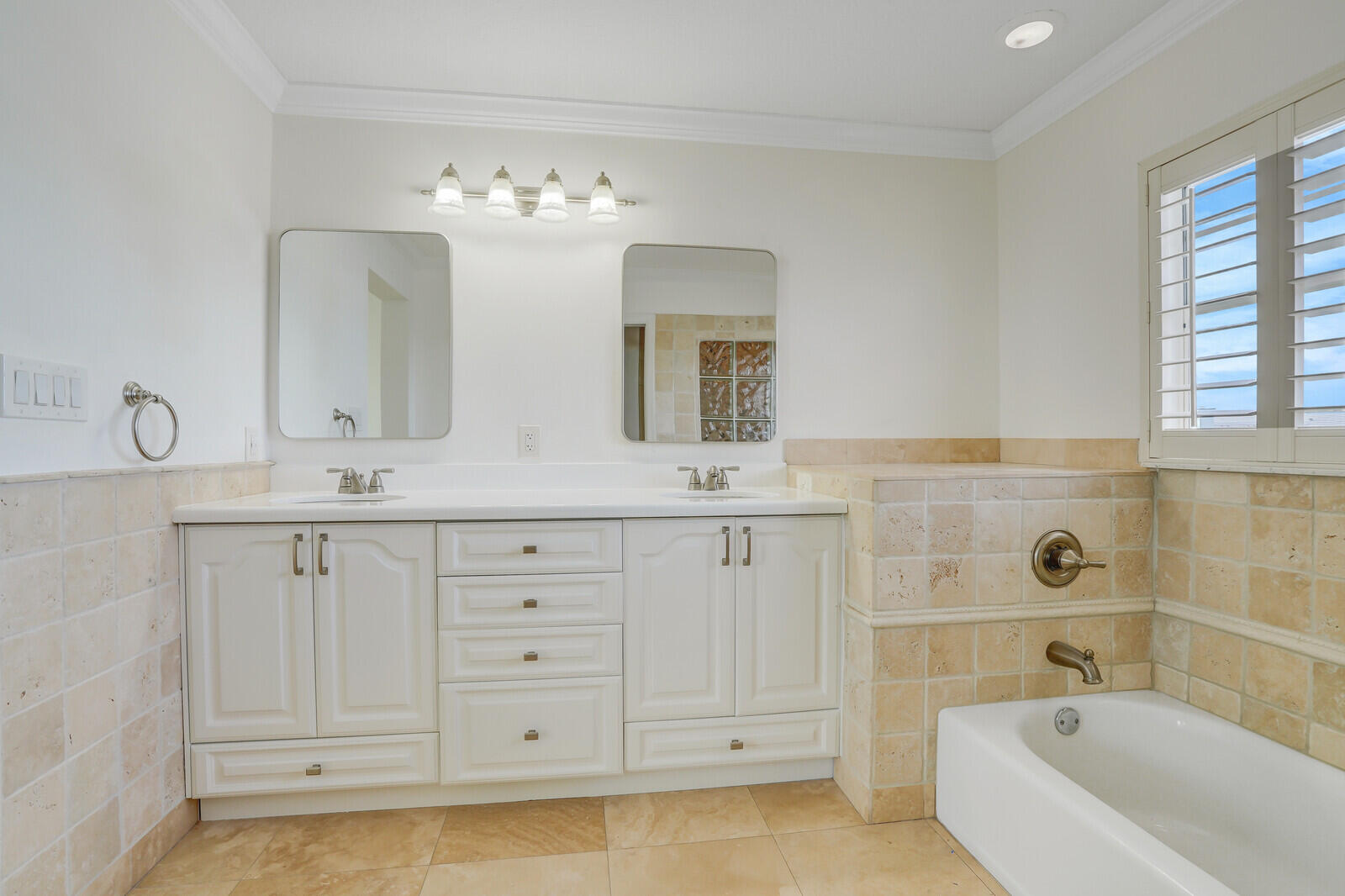 705 Mainsail Circle Jupiter, FL 33477 - Photo 34 of 51 a bathroom with a double vanity sink a mirror a bathtub and