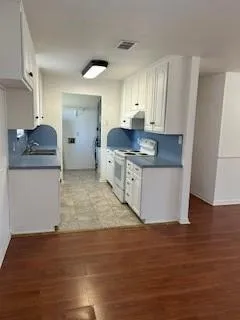 a kitchen with stainless steel appliances granite countertop a sink and a stove