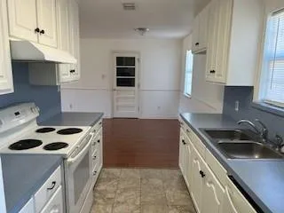 a kitchen that has a sink and a stove