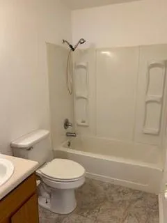 a bathroom with a toilet a sink and shower