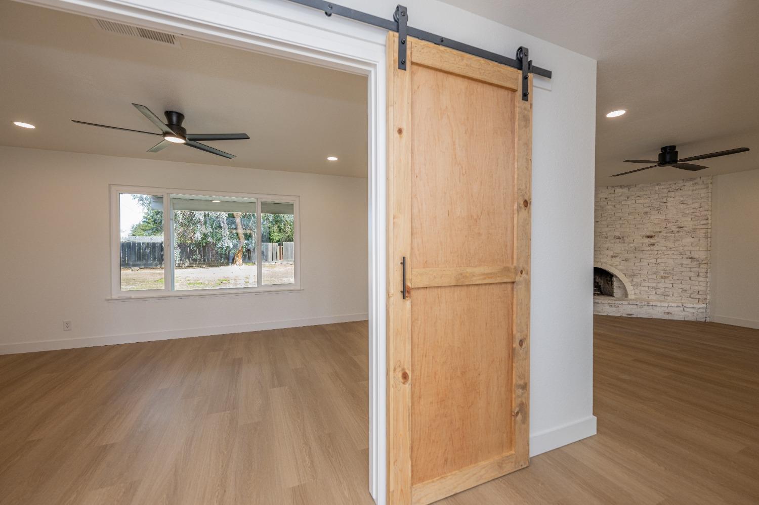 41175 Grove Circle Madera, CA 93636 - Photo 20 of 39 a view of hallway with a large window and wooden floor