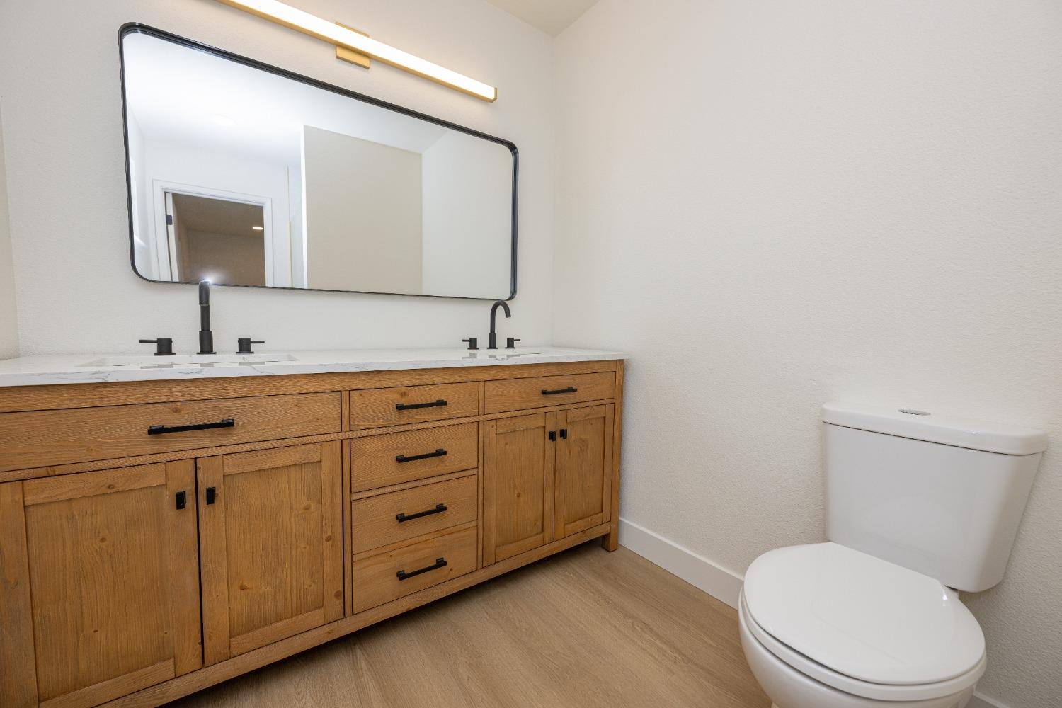 41175 Grove Circle Madera, CA 93636 - Photo 31 of 39 a bathroom with a toilet sink and mirror