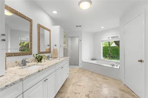 a spacious bathroom with a granite countertop sink mirror and a