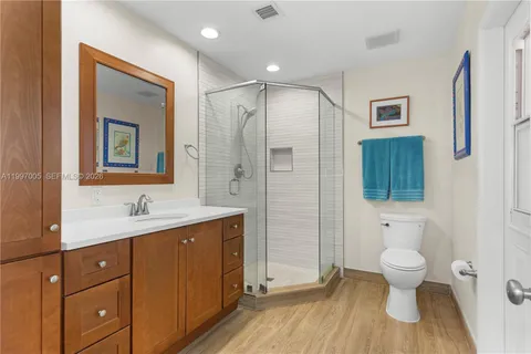 a bathroom with a toilet a sink and mirror