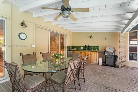 a dining room with furniture and a floor to ceiling window