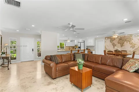 a living room with furniture and kitchen view