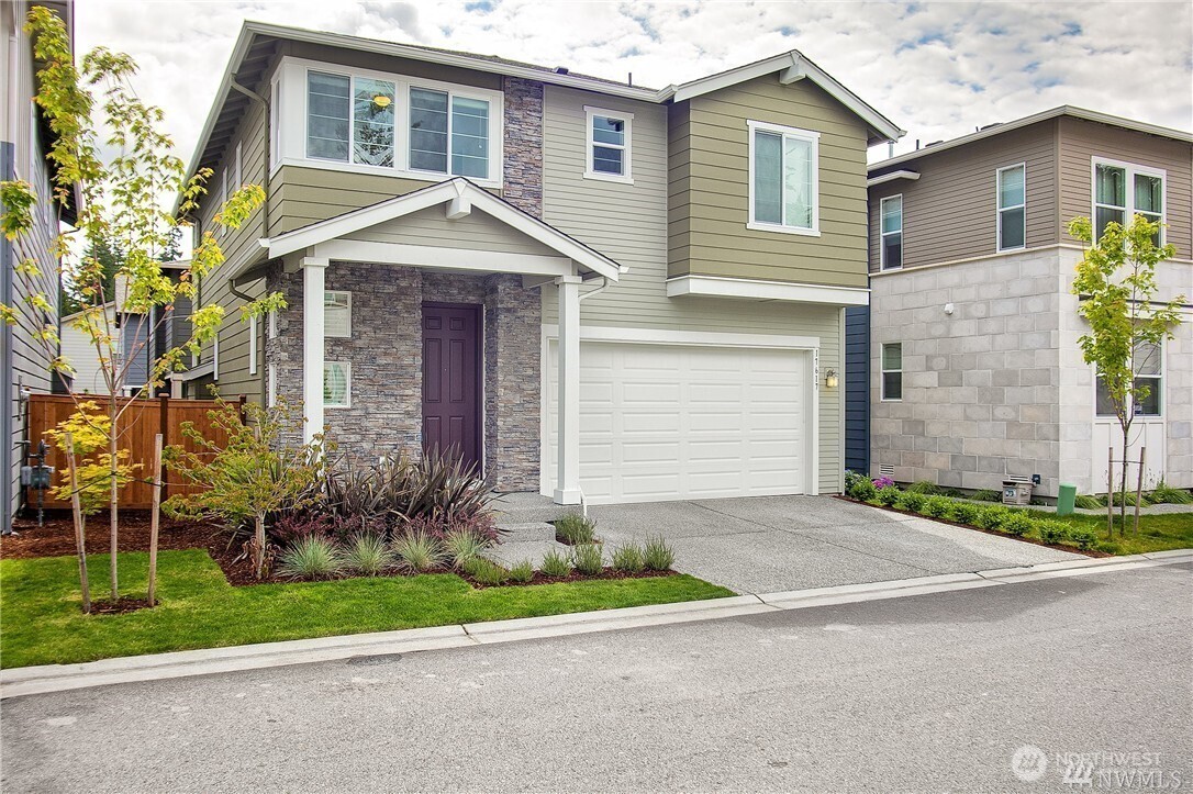 a front view of a house with garden