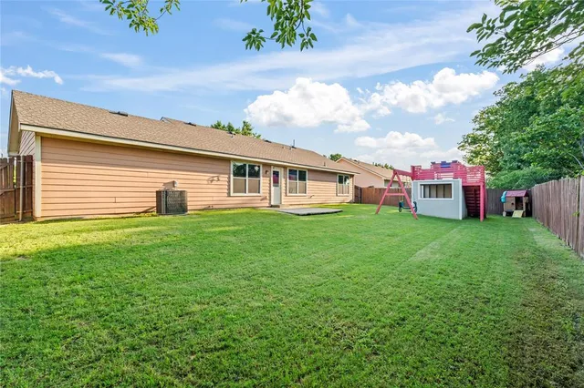 a front view of a house with a garden and yard