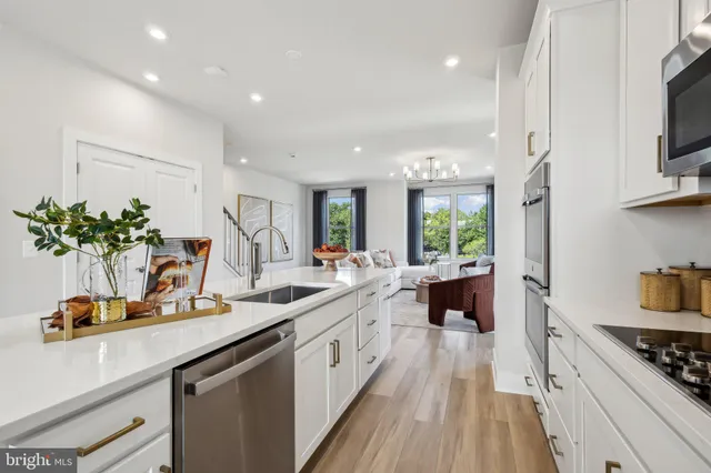 a kitchen with a sink stove and a refrigerator