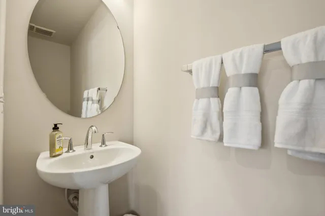 a bathroom with a sink and mirror