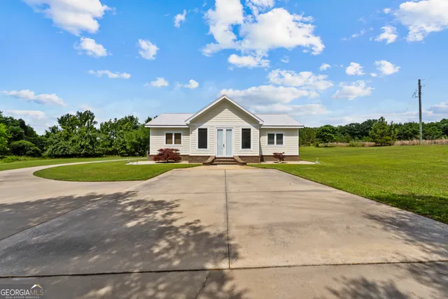 a view of house with yard and green space