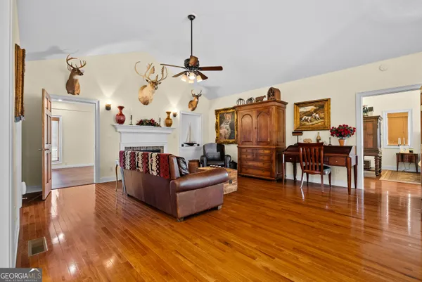 a view of living room filled with furniture and wooden floor