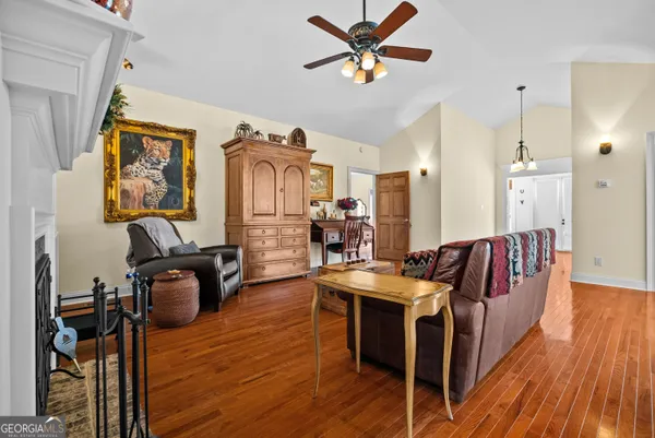 a living room with furniture and a wooden floor