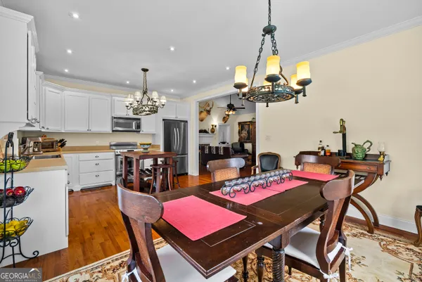 a view of a dining room with furniture and chandelier