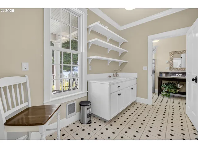 a bathroom with a sink a mirror a vanity and a shower