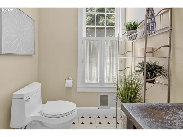a bathroom with a toilet a sink and a window