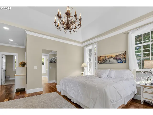 a bedroom with a large bed mirror and a window