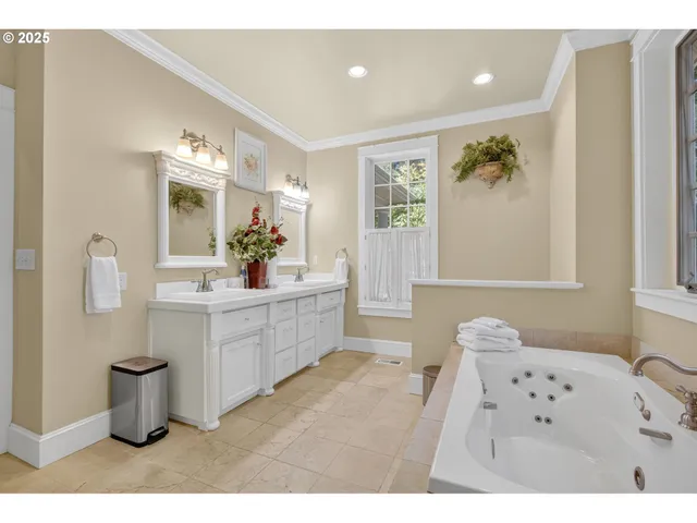 a bathroom with a sink mirror toilet and window