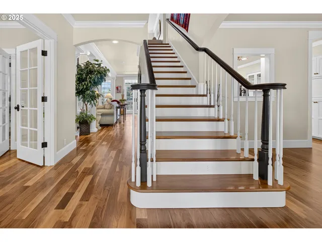 a view of entryway and hall with wooden floor