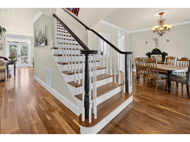 a view of entryway and hall with wooden floor