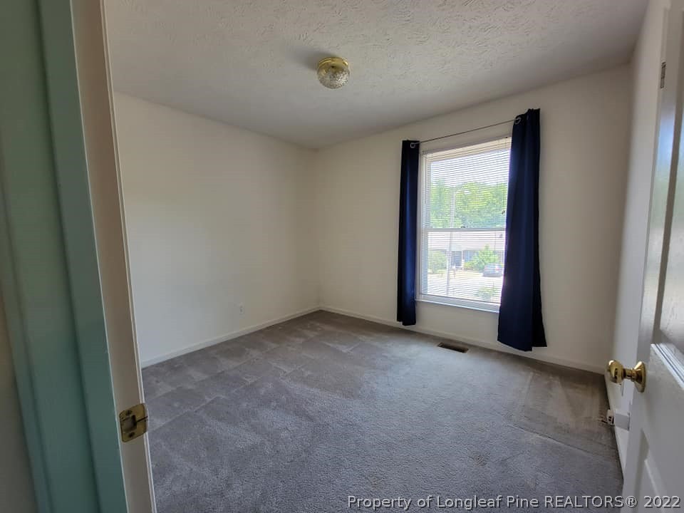 5025 Summer Ridge Road Fayetteville, NC 28303 - Photo 5 of 9 an empty room with windows