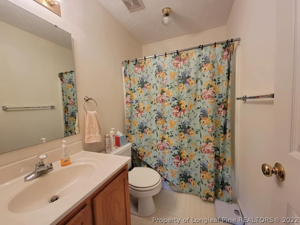 5025 Summer Ridge Road Fayetteville, NC 28303 - Photo 7 of 9 a bathroom with a sink toilet and shower