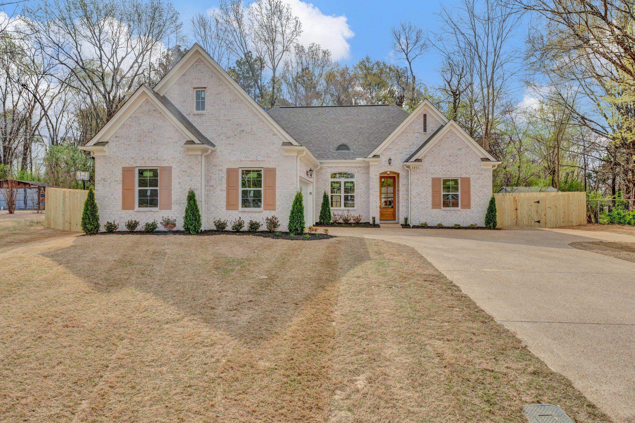 4056 Fonta Road Bartlett, TN 38002 - Photo 1 of 39 French country inspired facade with brick siding, driveway, a shingled roof, and fence