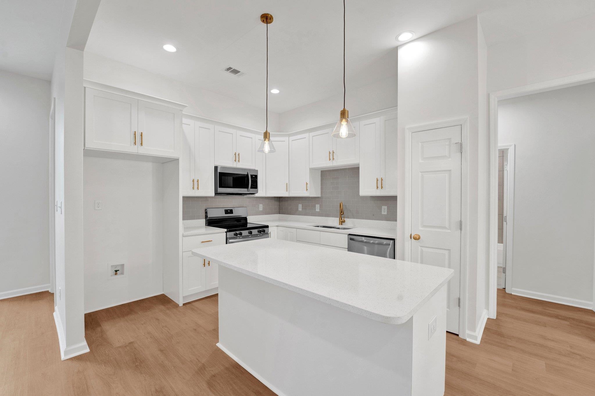 4056 Fonta Road Bartlett, TN 38002 - Photo 12 of 39 Kitchen featuring white cabinetry, a sink, stainless steel appliances, and backsplash