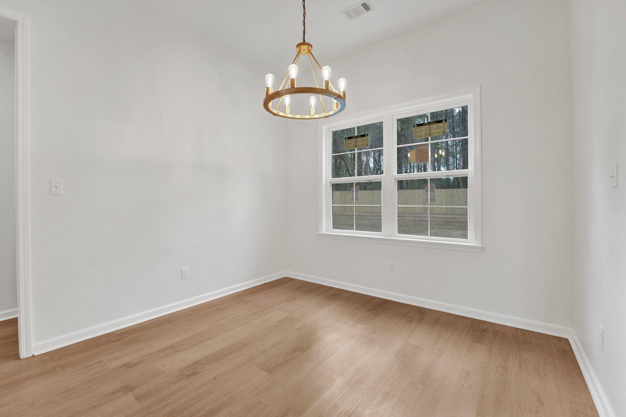 4056 Fonta Road Bartlett, TN 38002 - Photo 18 of 39 Spare room featuring baseboards, visible vents, a chandelier, and wood finished floors