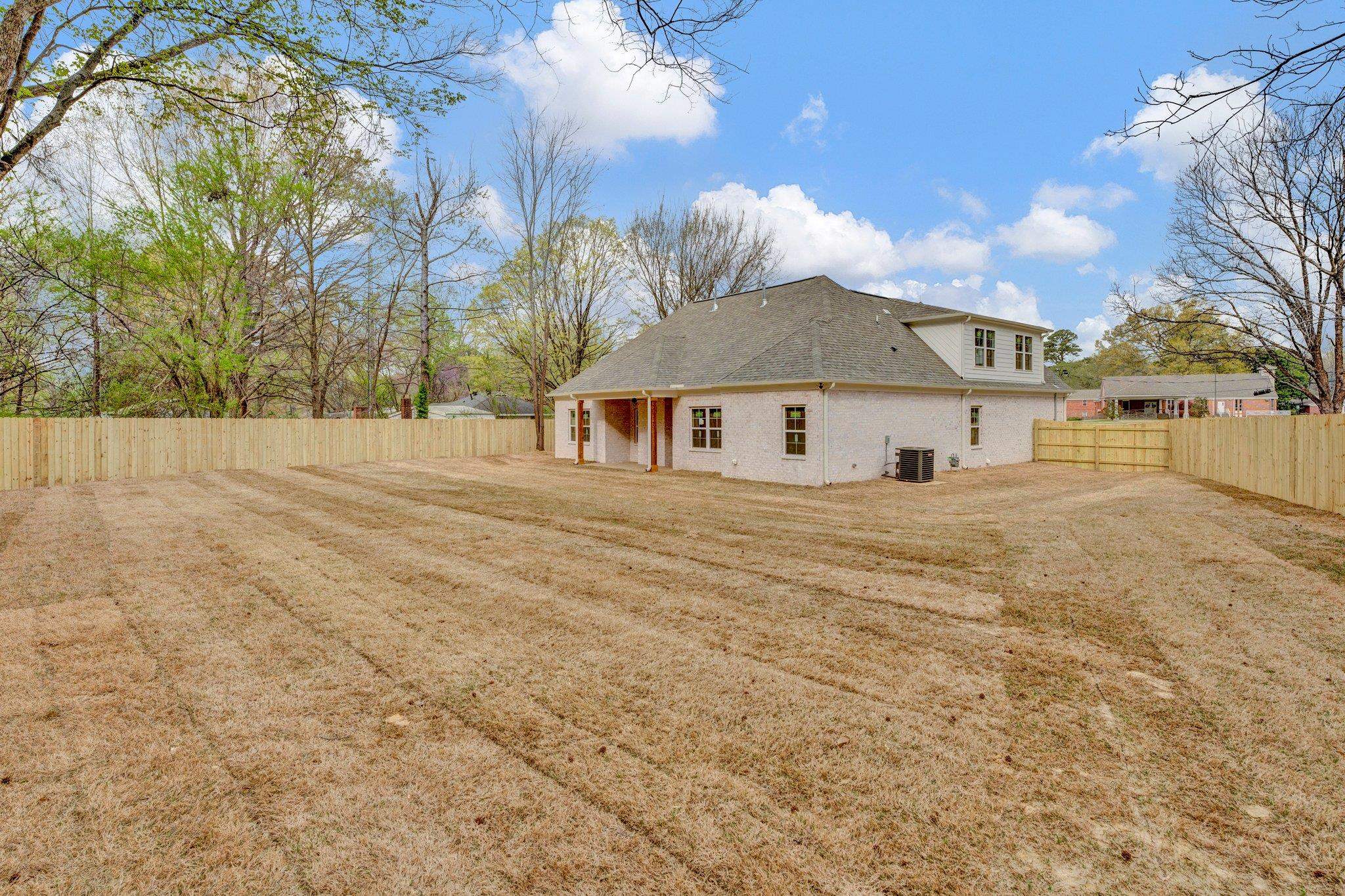 4056 Fonta Road Bartlett, TN 38002 - Photo 36 of 39 Exterior space with a fenced backyard, a lawn, a shingled roof, and central AC