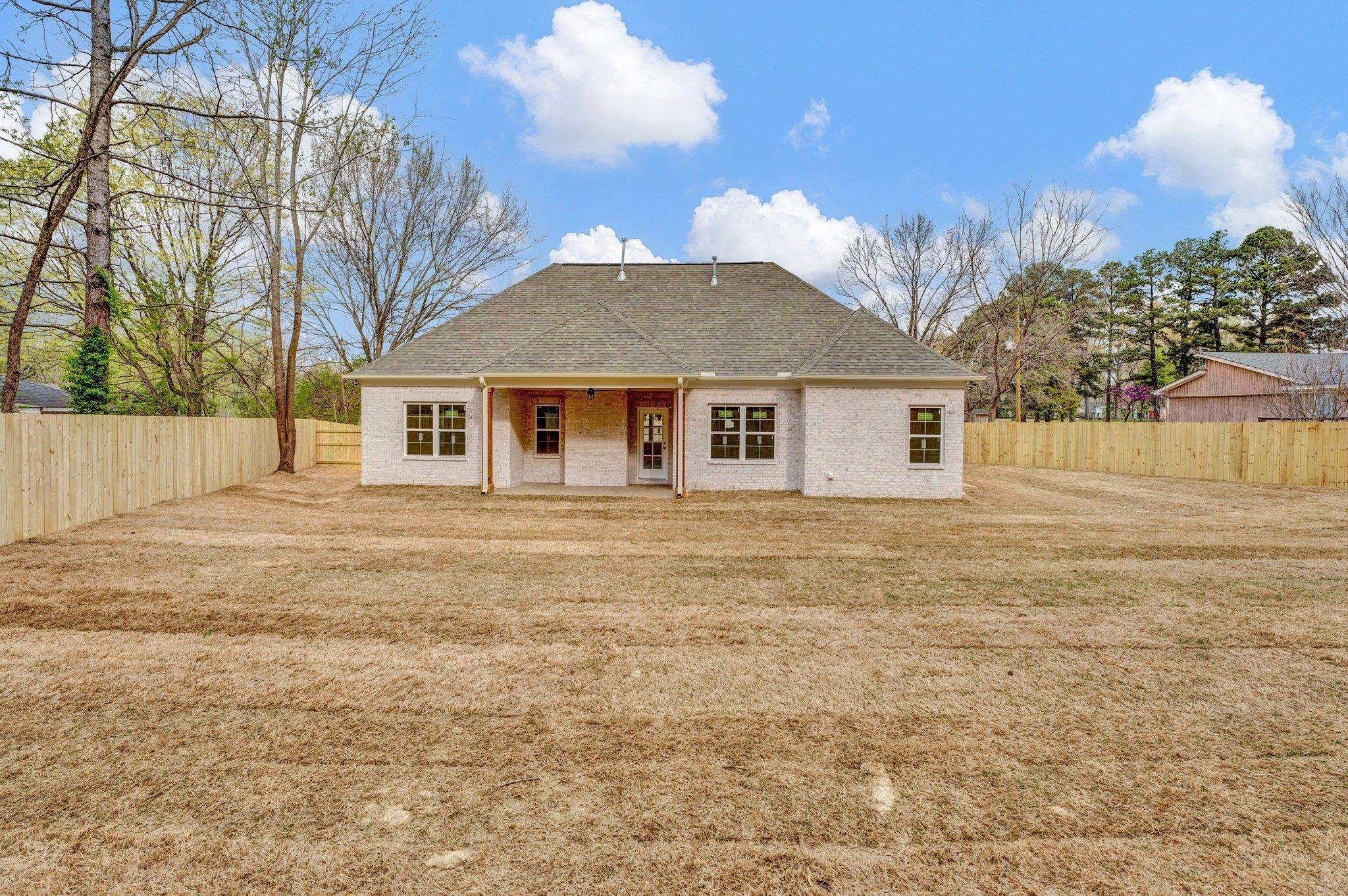4056 Fonta Road Bartlett, TN 38002 - Photo 38 of 39 Rear view of house with a fenced backyard, a lawn, and a shingled roof