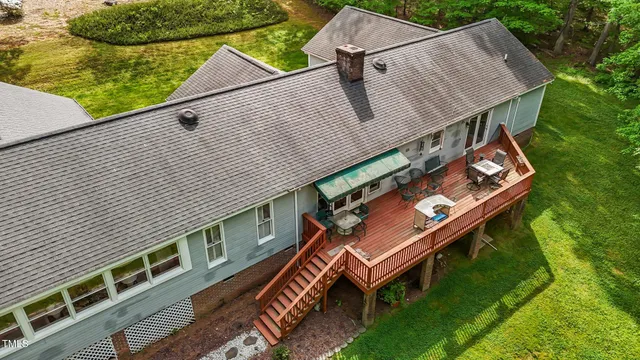 a view of a wooden deck and a yard with seating area