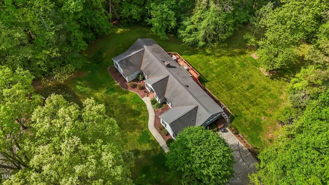 an aerial view of a house with yard