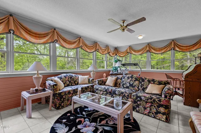 a bedroom with furniture and a large window