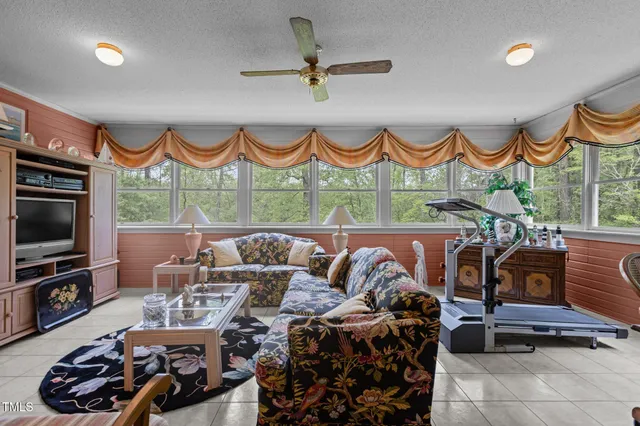 a living room with furniture a fireplace and a flat screen tv