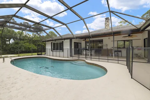 a front view of a house with a yard table and chairs