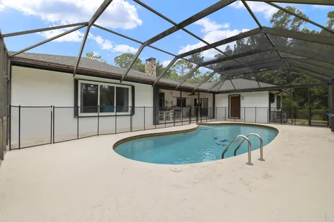 a front view of house with yard and trees around