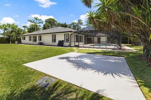 a vase of flowers sitting on a table with a garden
