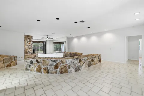 a kitchen with stainless steel appliances granite countertop a stove and white cabinets
