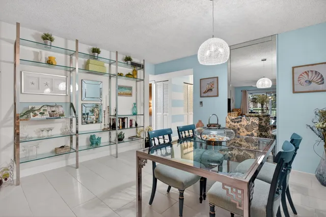 a view of dining room and kitchen with a table chairs and a large window