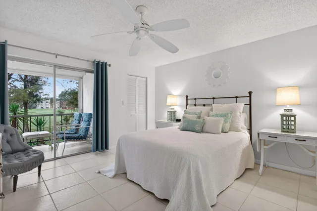 a bedroom with a bed and large mirror