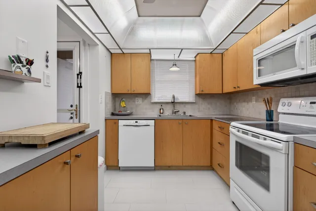 a kitchen with stainless steel appliances granite countertop a sink and a stove