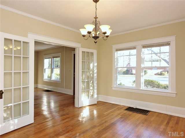 1413 Scales Street Raleigh, NC 27608 - Photo 11 of 24 a view of an empty room with a window and wooden floor